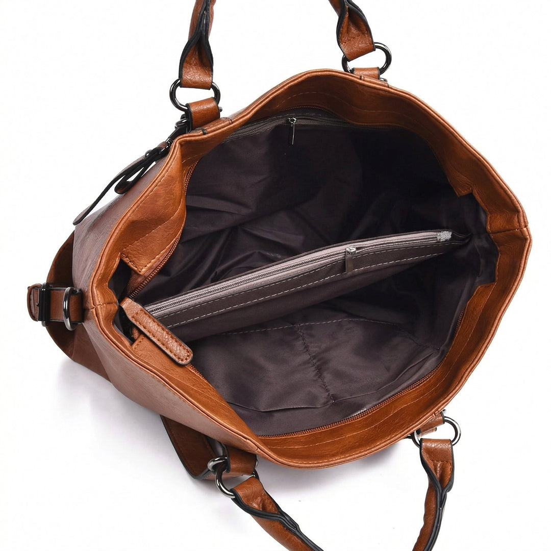 Innenansicht Schultertasche, dunkelgraues Futter mit Reißverschlusstasche und Fächern